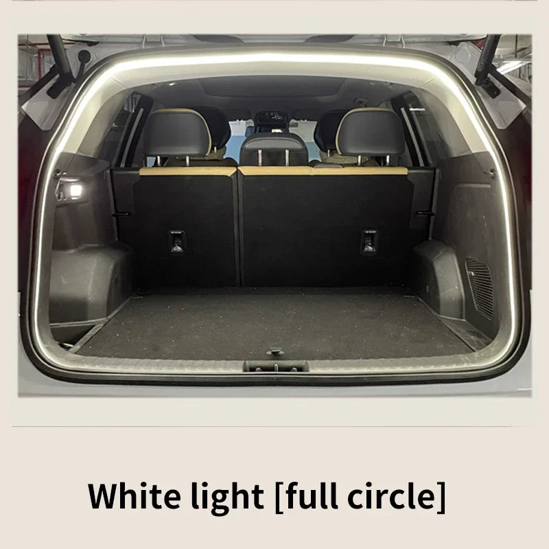 Open car trunk with white light illuminating the interior